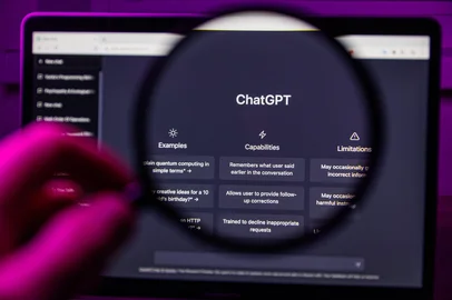 Chat GPT OpenAI through magnifying glass on screen <!-- NICAID(16054054) -->