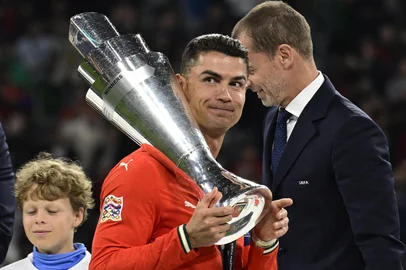 Portugal's forward #07 Cristiano Ronaldo carries the trophy after winning the UEFA Nations League final football match between Portugal and Spain in Munich, southern Germany on June 8, 2025. (Photo by John MACDOUGALL / AFP)<!-- NICAID(16055271) -->